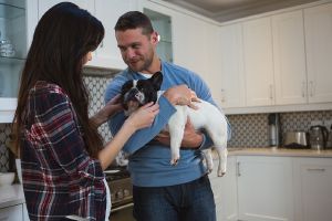 Happy couple playing with their adopted dog